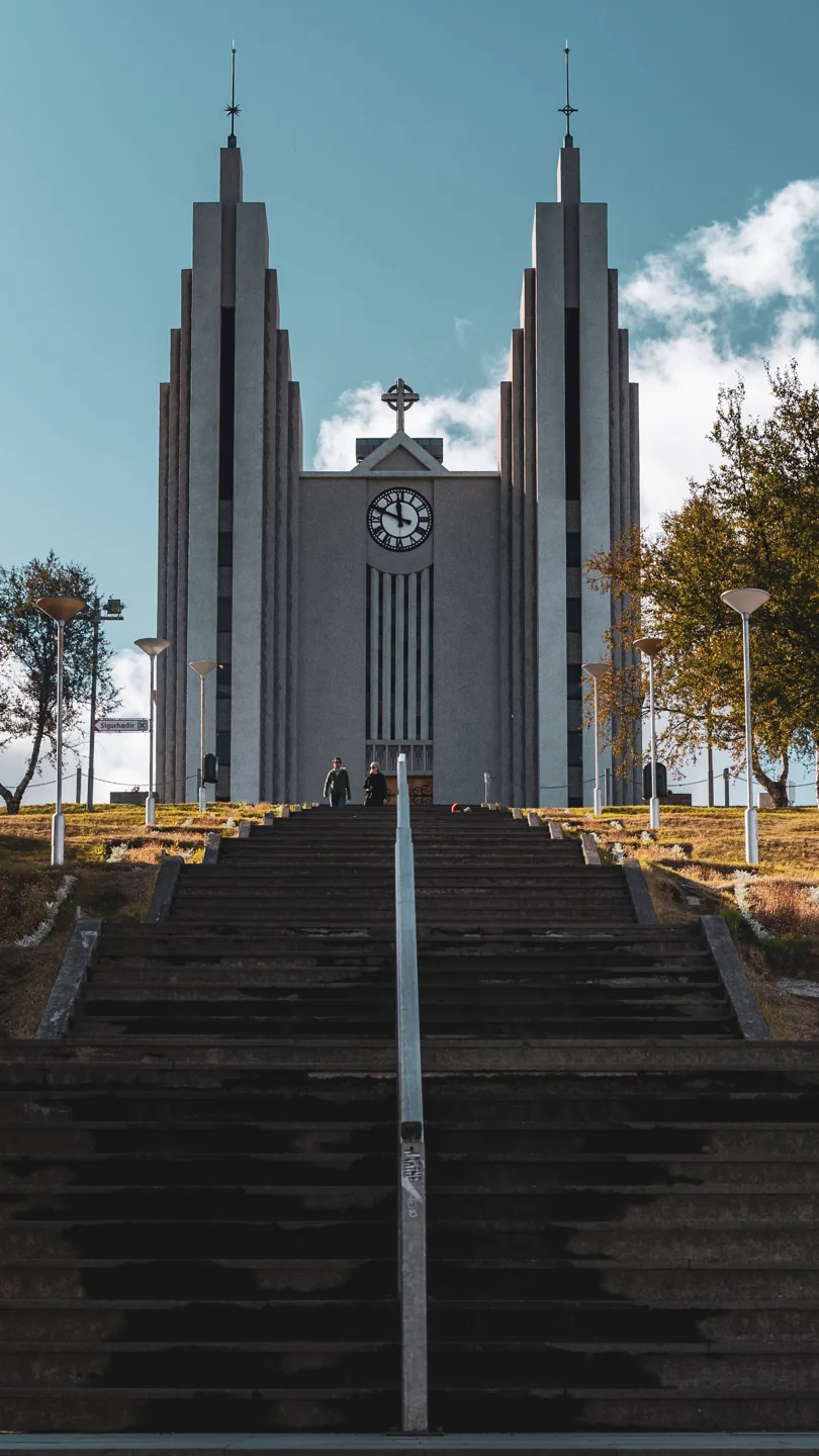 The twin concrete towers of Akureyrarkirkja above its broad central stairway