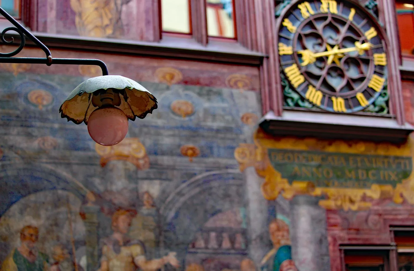 Painted facade, astronomical clock and projecting figure at Basel’s red Town Hall