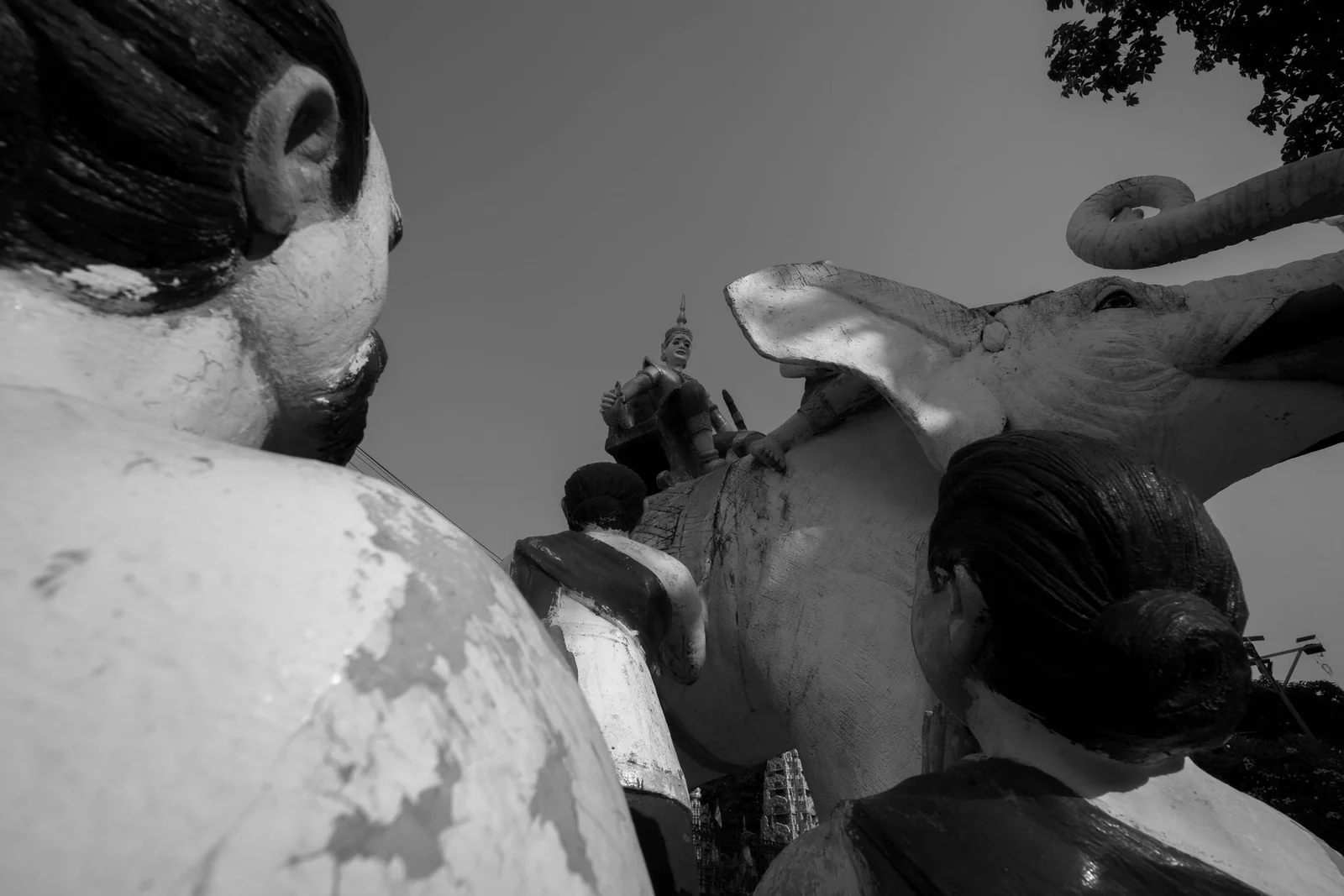 Black-and-white detail of the elephant and kneeling figures at Wat Damrey Sor, the White Elephant Pagoda in Battambang.