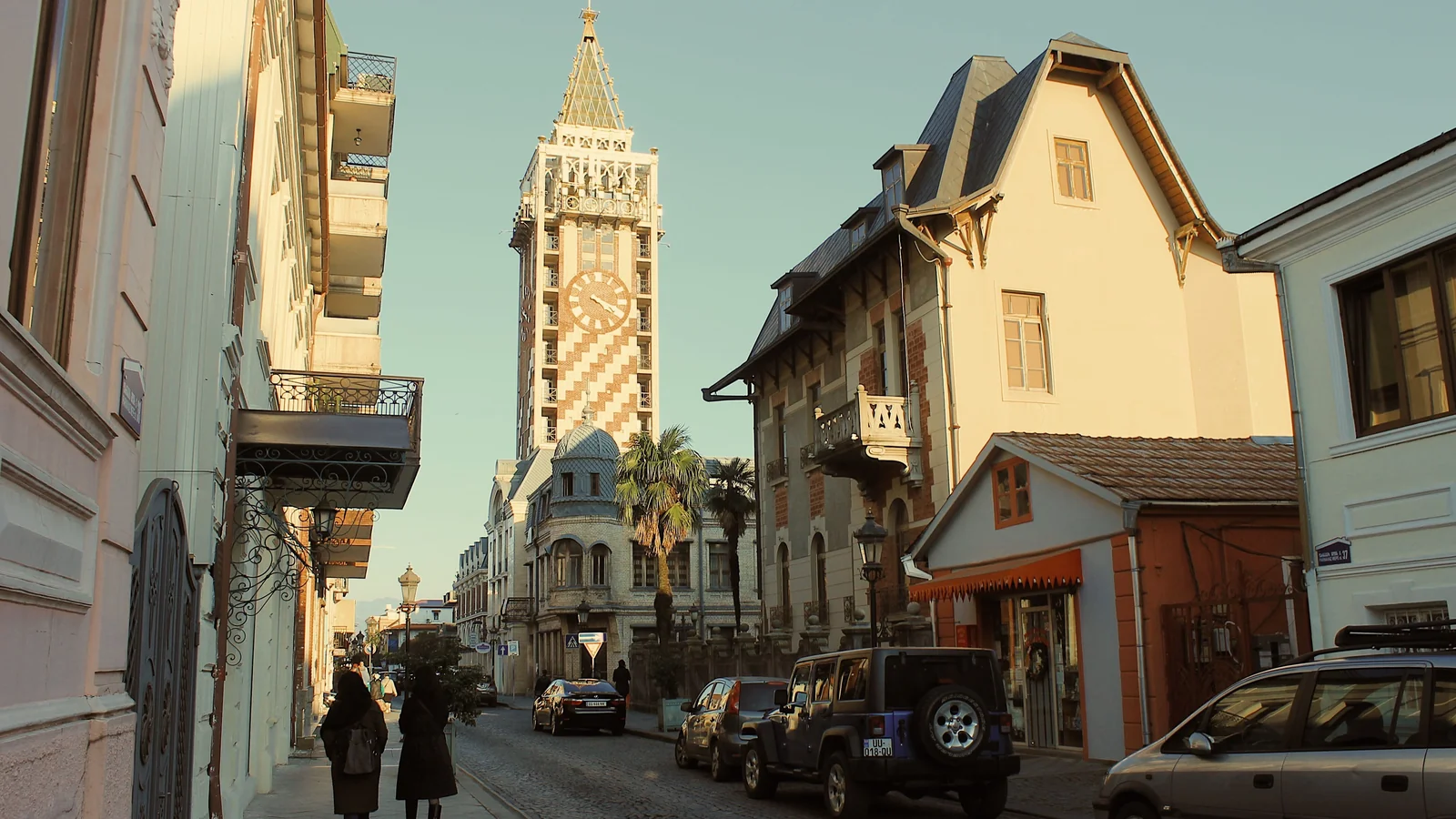 A street approaching Batumi Piazza’s patterned clock tower.