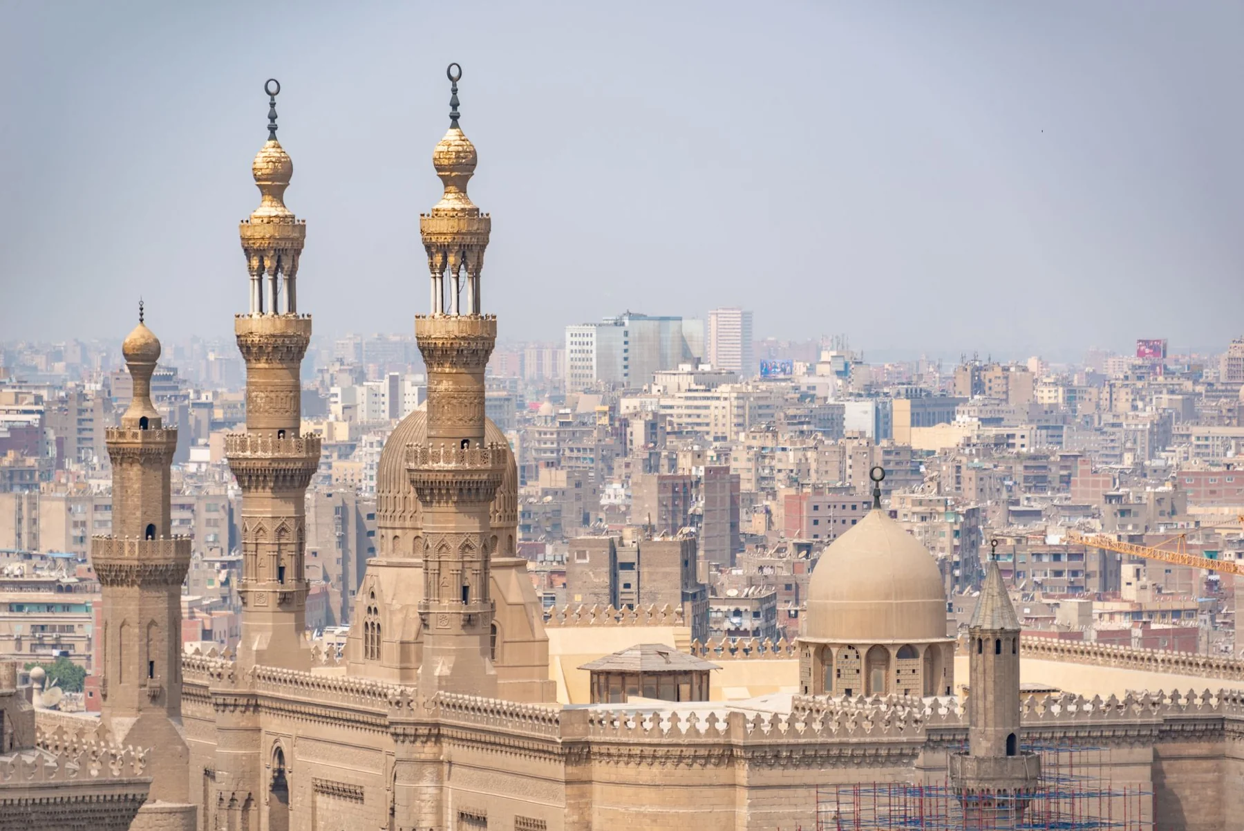 Al-Rifa’i Mosque’s paired minarets and dome with Cairo behind