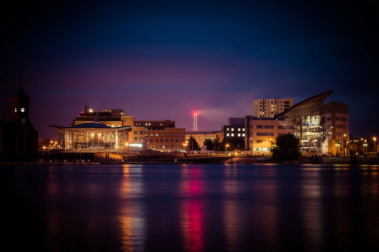 Illuminated buildings reflected in Cardiff Bay at night