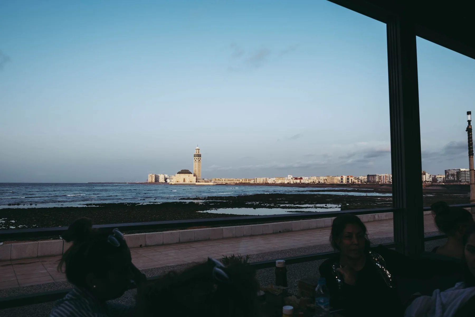 Hassan II Mosque across the Casablanca shoreline, seen from a seafront café