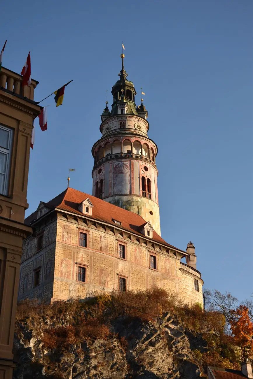 Český Krumlov’s painted Castle tower above the rocky river bank