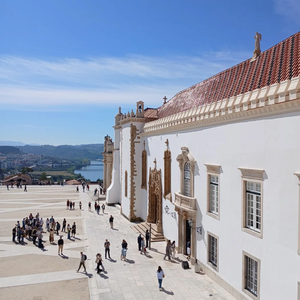 Visitors in the historic University of Coimbra courtyard