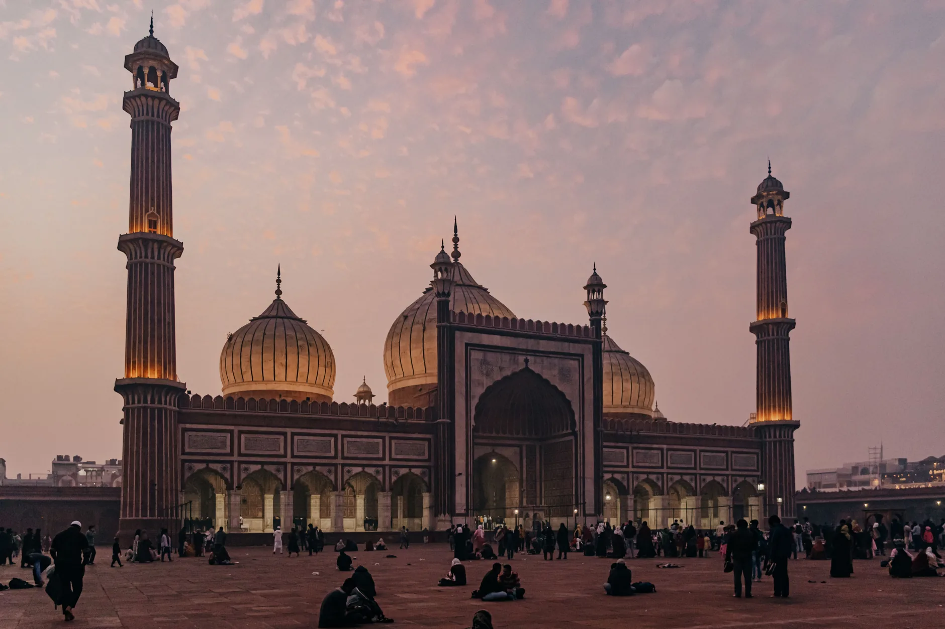 Jama Masjid’s domes and minarets above its courtyard in Old Delhi at dusk