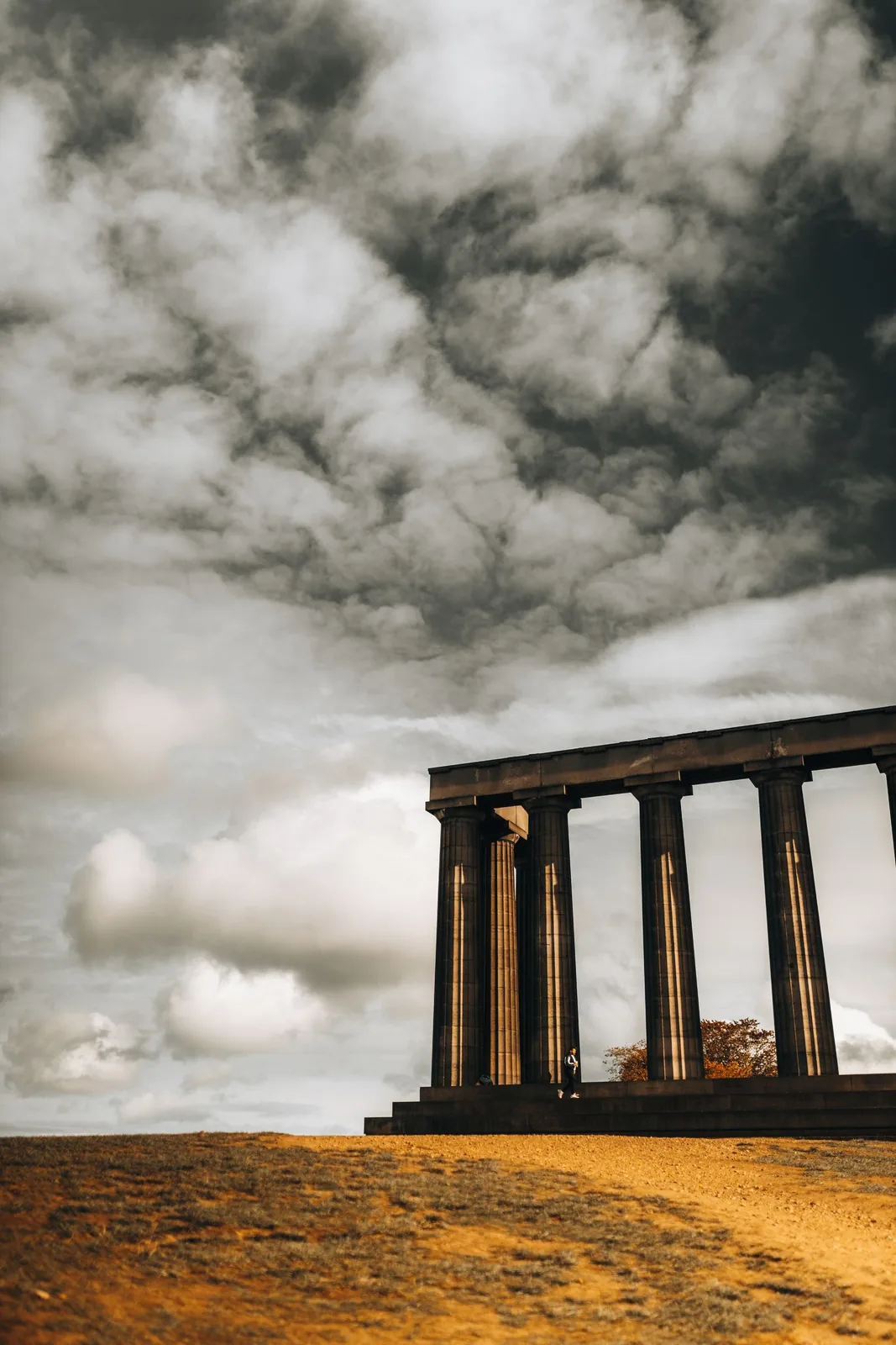 The National Monument on Calton Hill under clouds in Edinburgh