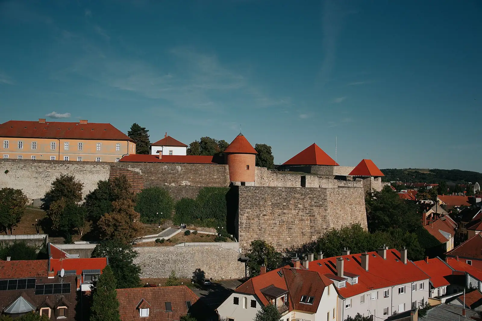 Eger Castle’s stone ramparts and red-roofed towers above the old-town houses