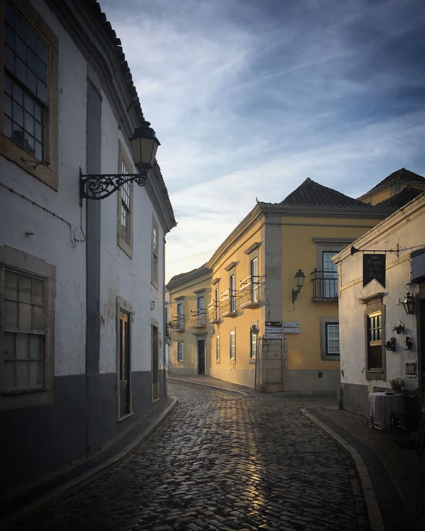 Sunlit alley with traditional buildings in Faro