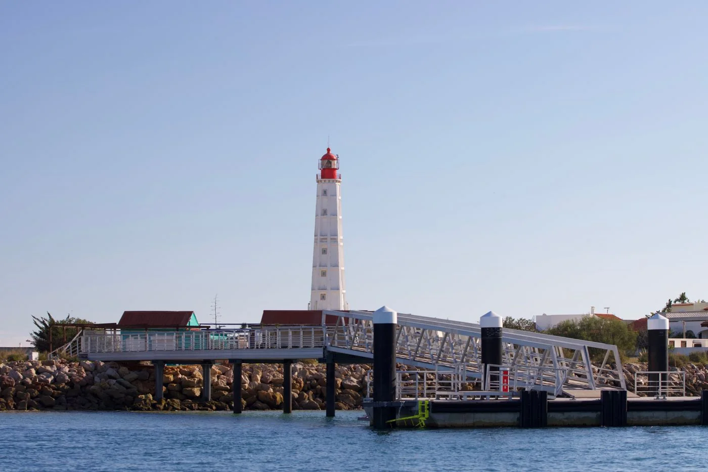 Lighthouse in Farol village on an island reached from Faro