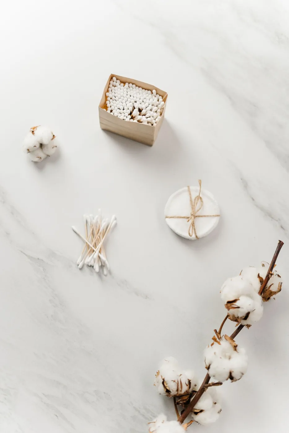 Soap and toiletries arranged on a pale surface