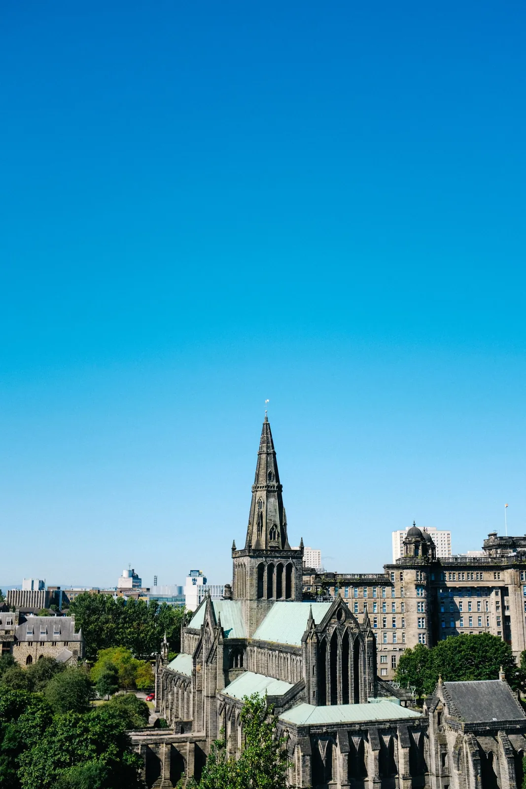 The spire of Glasgow Cathedral against a clear blue sky