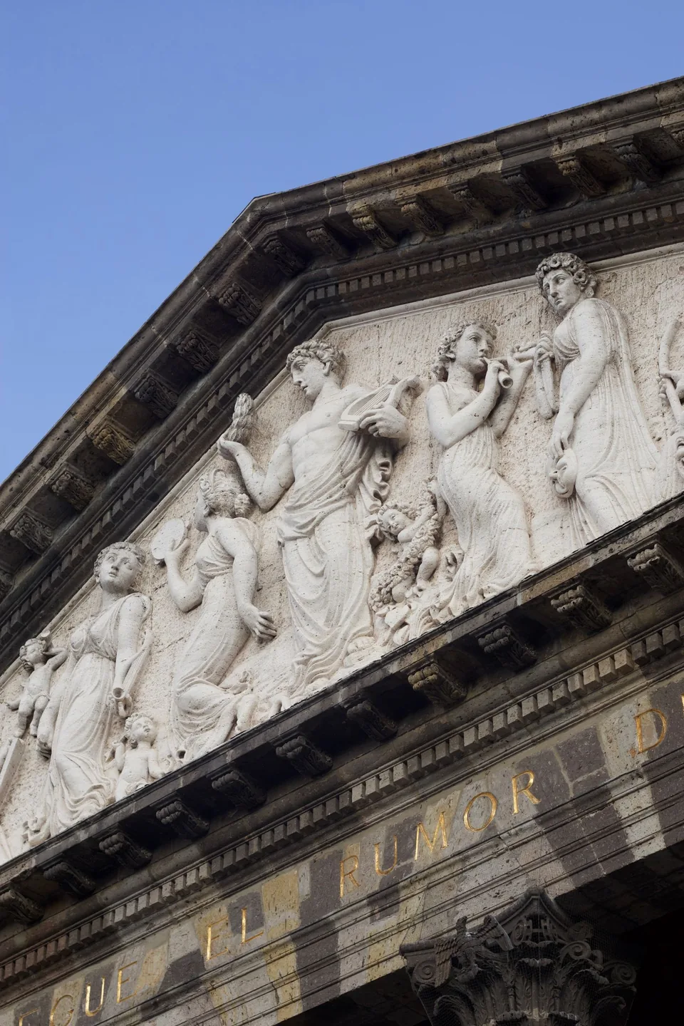 Carved classical figures and stone pediment above the portico of Guadalajara’s Teatro Degollado