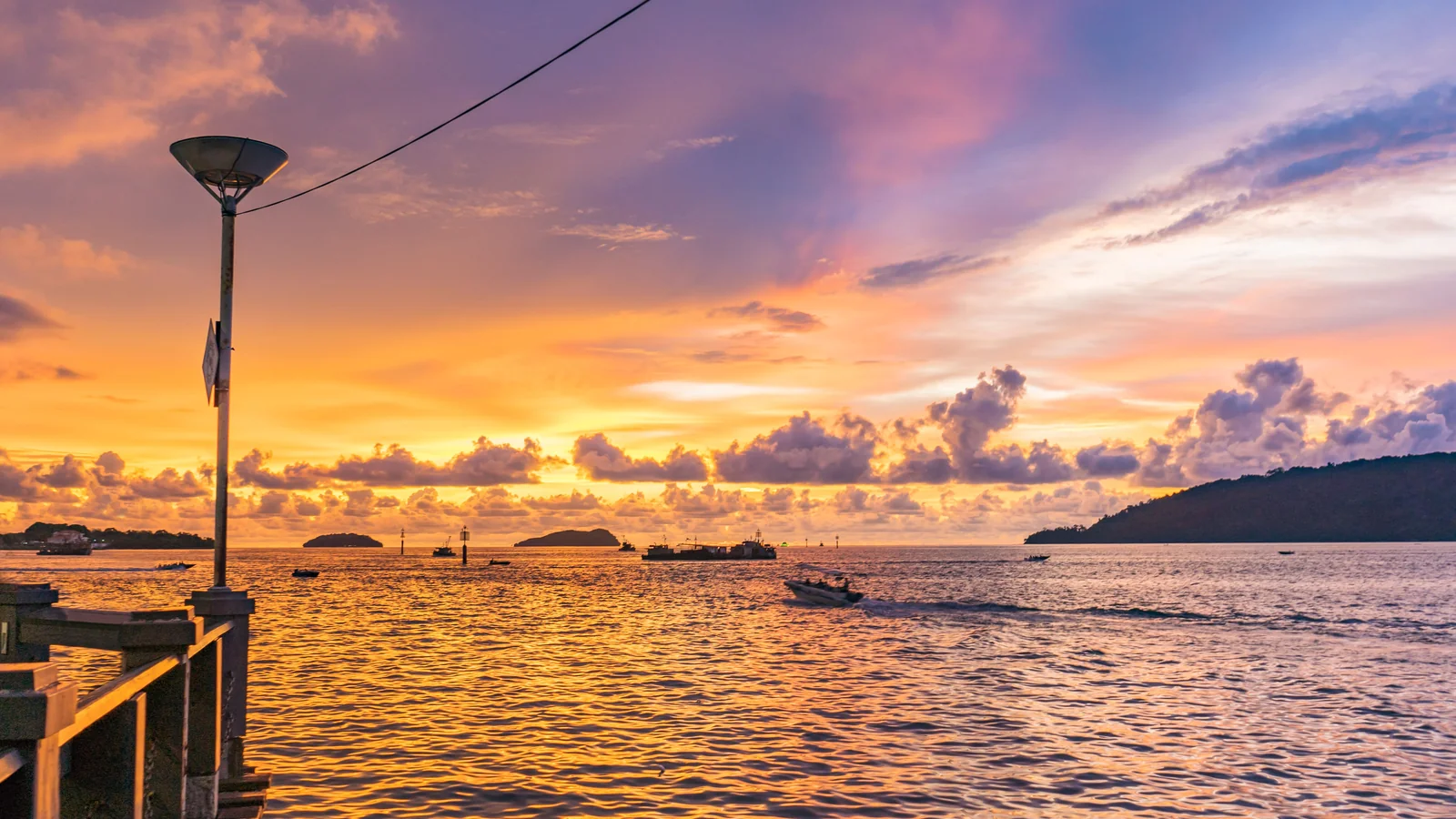 Warm sunset over a pier and offshore islands in Kota Kinabalu, Sabah.