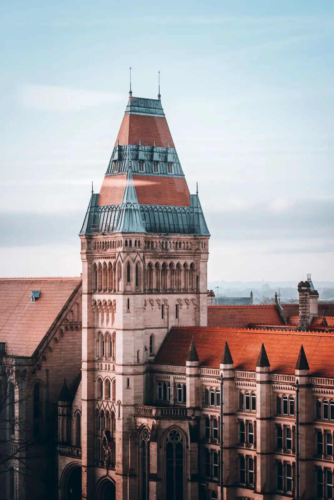 Historic tower and brick buildings on the University of Manchester campus