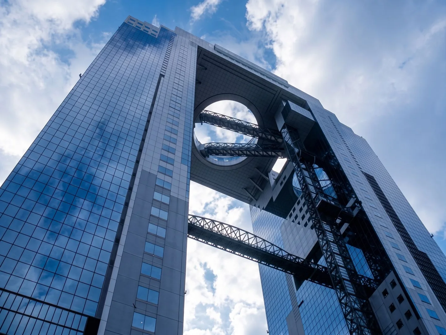 The twin towers and circular rooftop opening of Umeda Sky Building seen from below