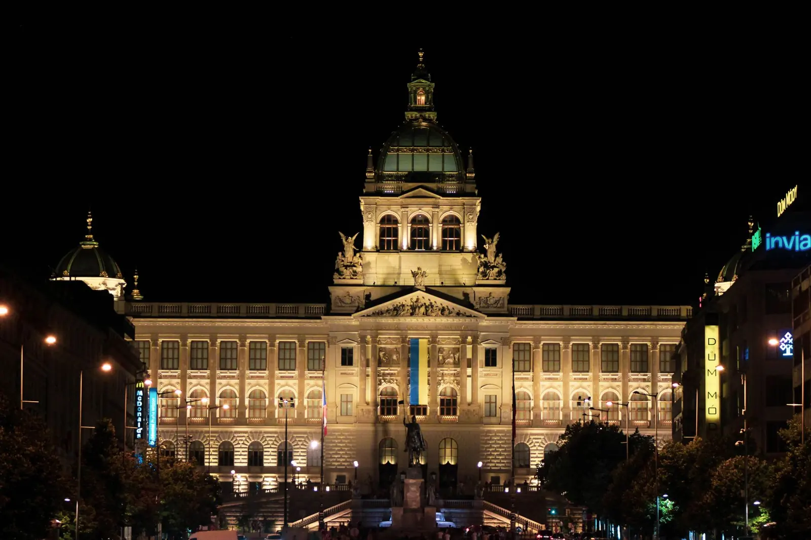 The illuminated Historical Building of Prague’s National Museum at the top of Wenceslas Square