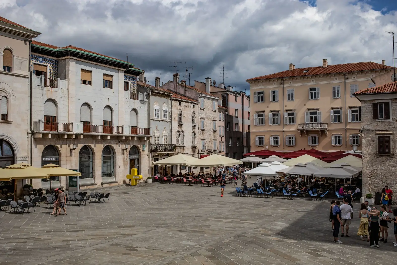 Historic buildings and café terraces around Pula’s Forum