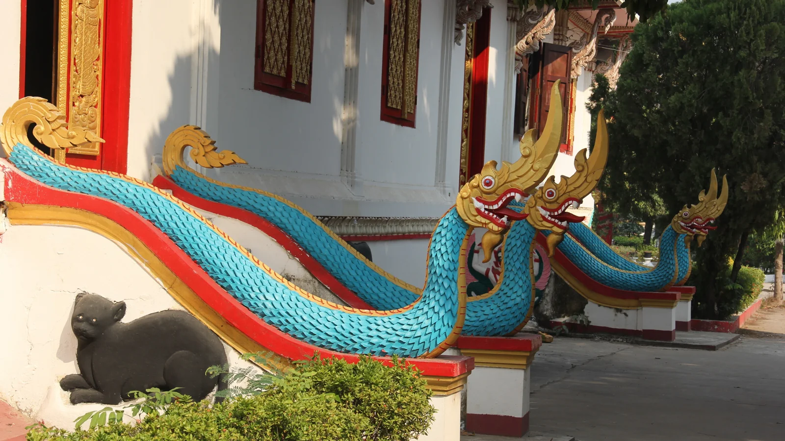 Colourful naga guardians beside the temple steps at Wat Sainyaphum in Savannakhet.