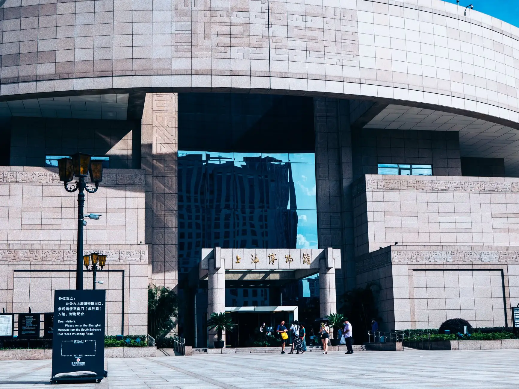 The curved stone exterior and signed entrance of Shanghai Museum on People’s Square
