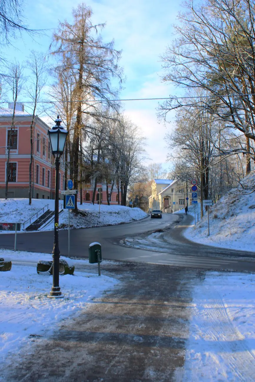 A snowy street at Tartu’s Toome Hill edge, with the K. E. von Baeri street sign and historic façades