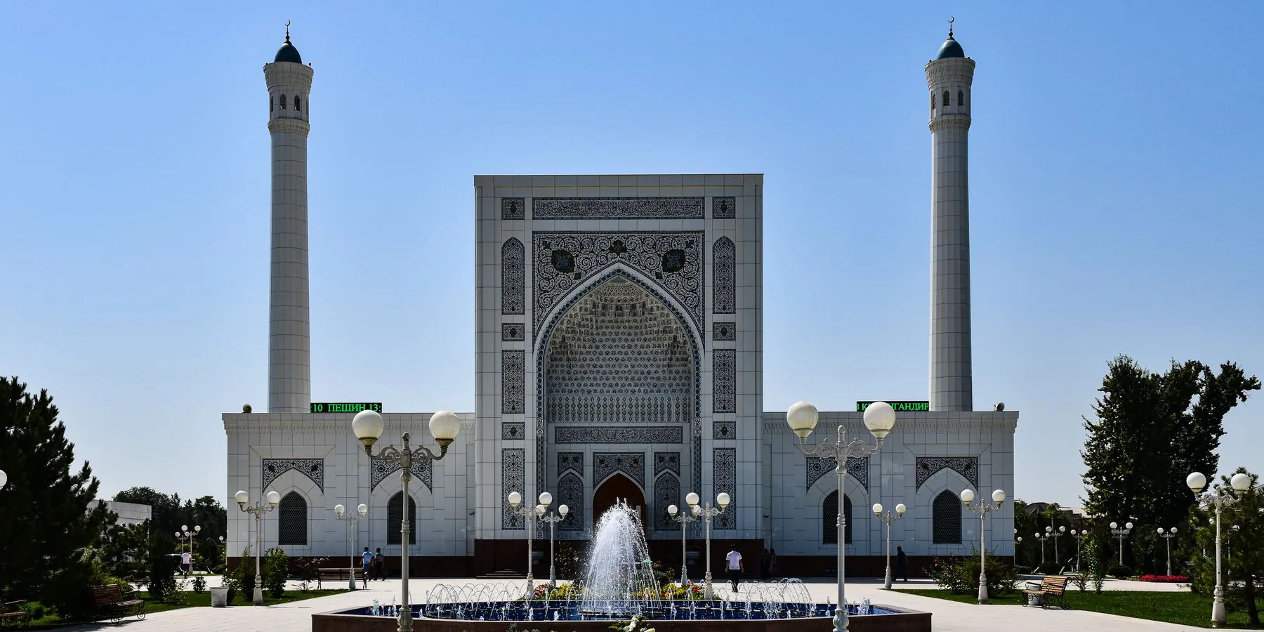 White marble facade, twin minarets and fountain at Minor Mosque in Tashkent