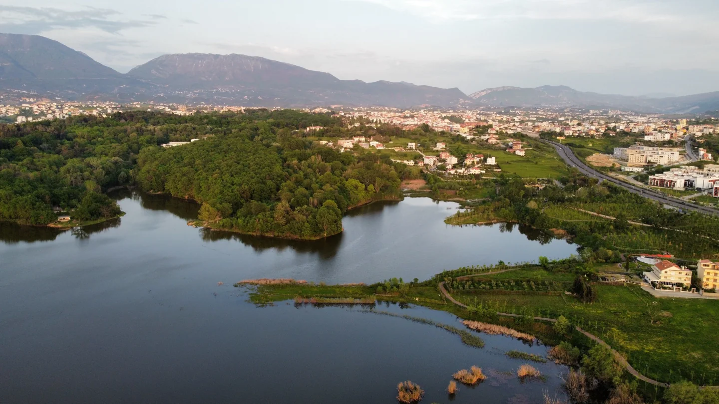 Artificial Lake and wooded Grand Park in Tirana with the city and mountain ridge beyond