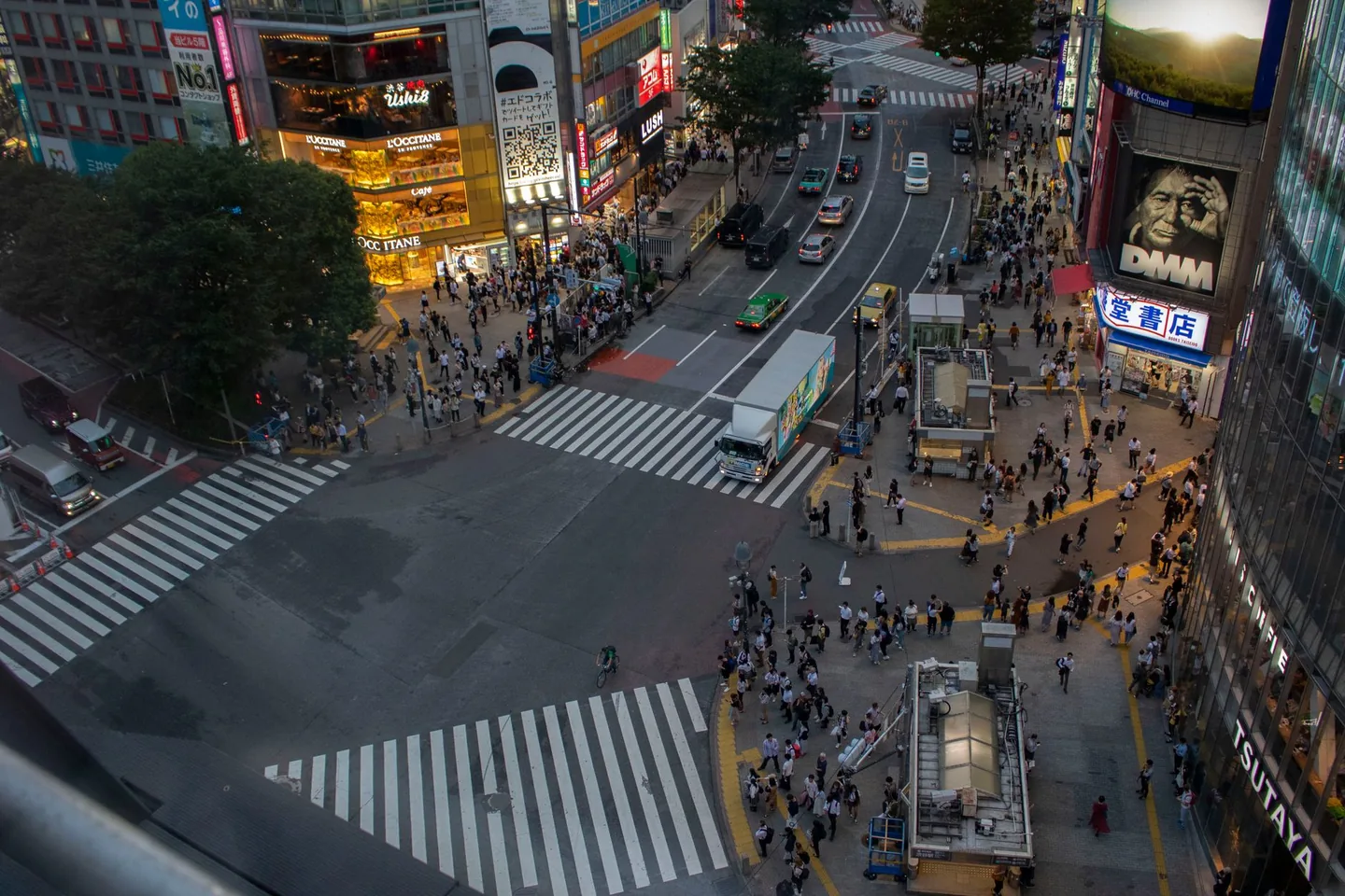 Shibuya Scramble Crossing and surrounding buildings seen from above at dusk