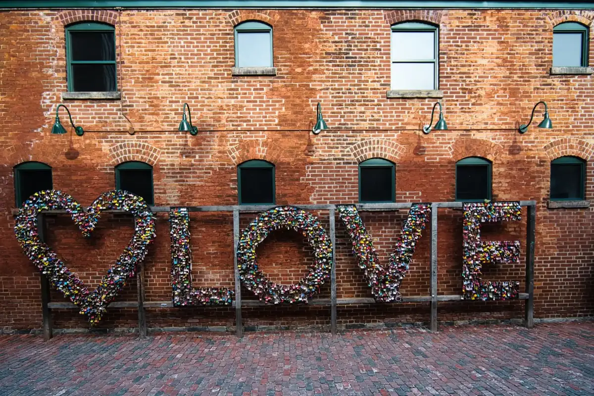 Love Locks installation against historic brick buildings in Toronto’s Distillery District