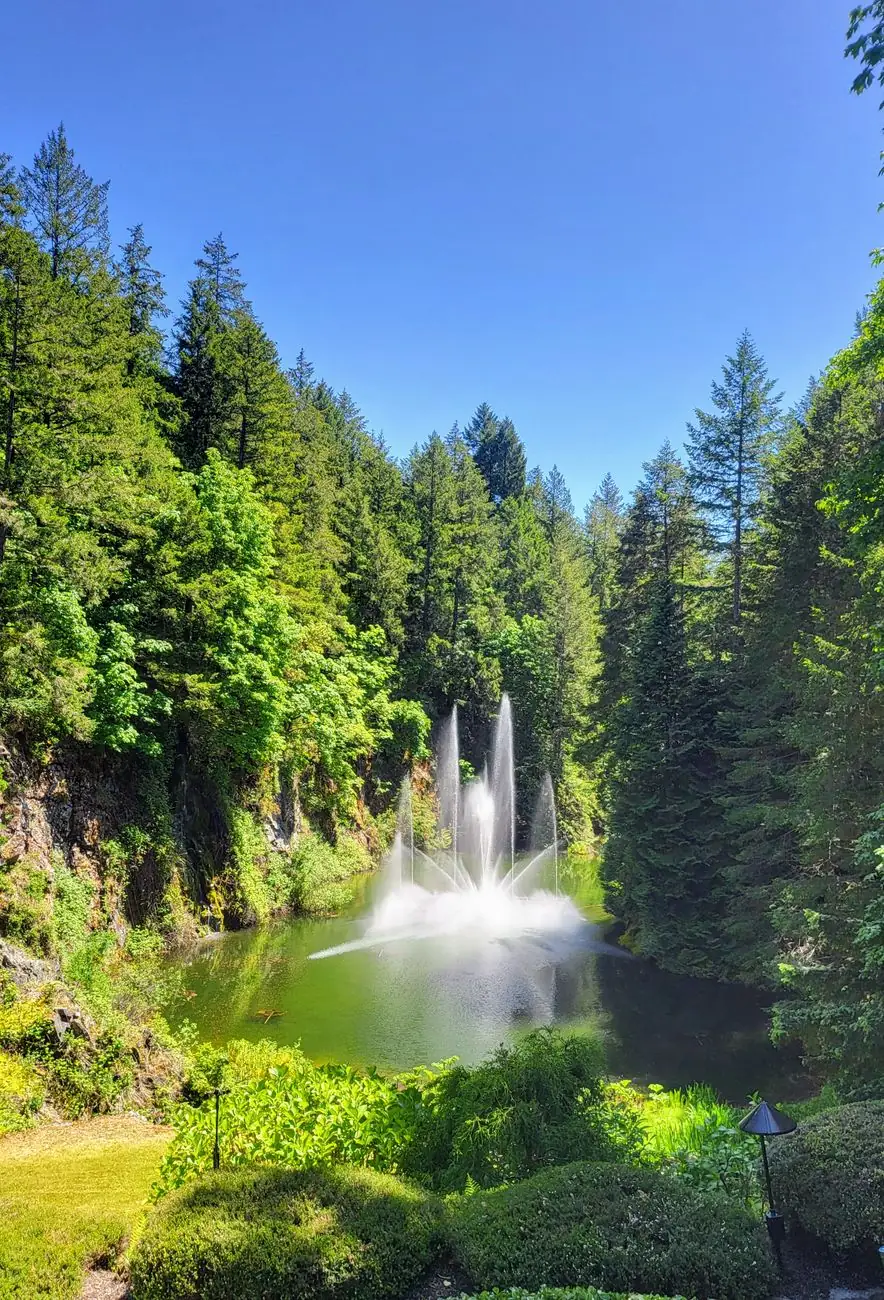 A fountain among the green quarry walls and plantings at Butchart Gardens