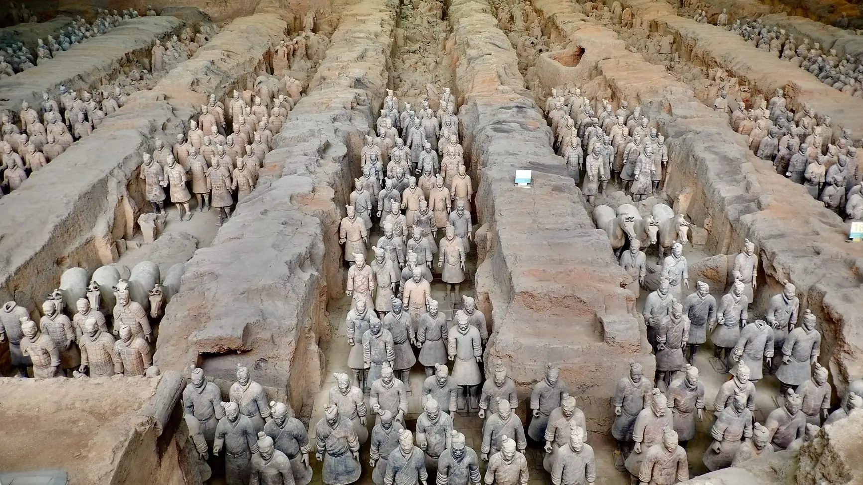 Rows of Terracotta Army figures between earthen partitions in Pit 1 near Xi’an