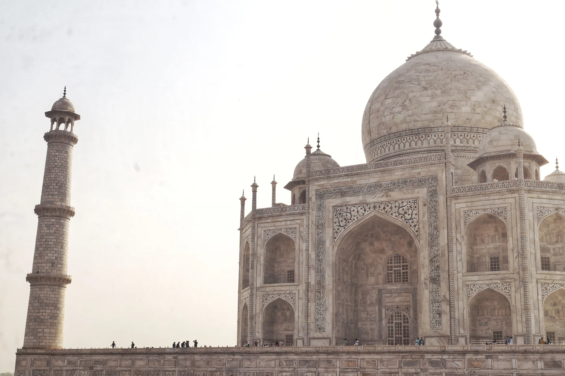 The Taj Mahal’s white marble dome and minarets rise above Agra on a clear day