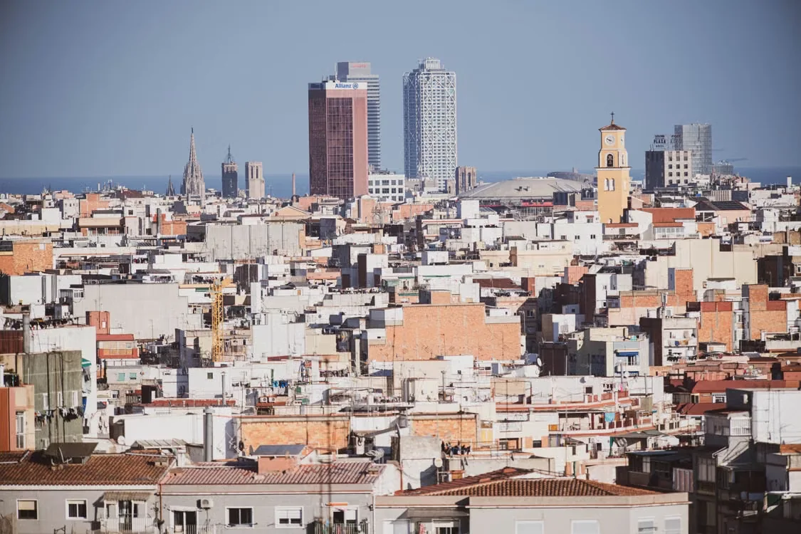 Barcelona rooftops with the Sagrada Familia and seafront towers in the distance