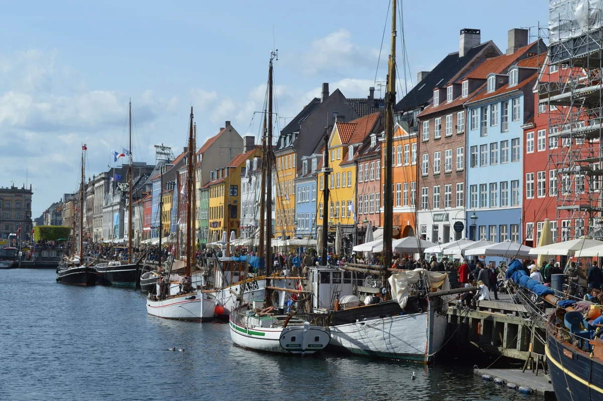 Colourful Nyhavn waterfront buildings and moored boats in Copenhagen