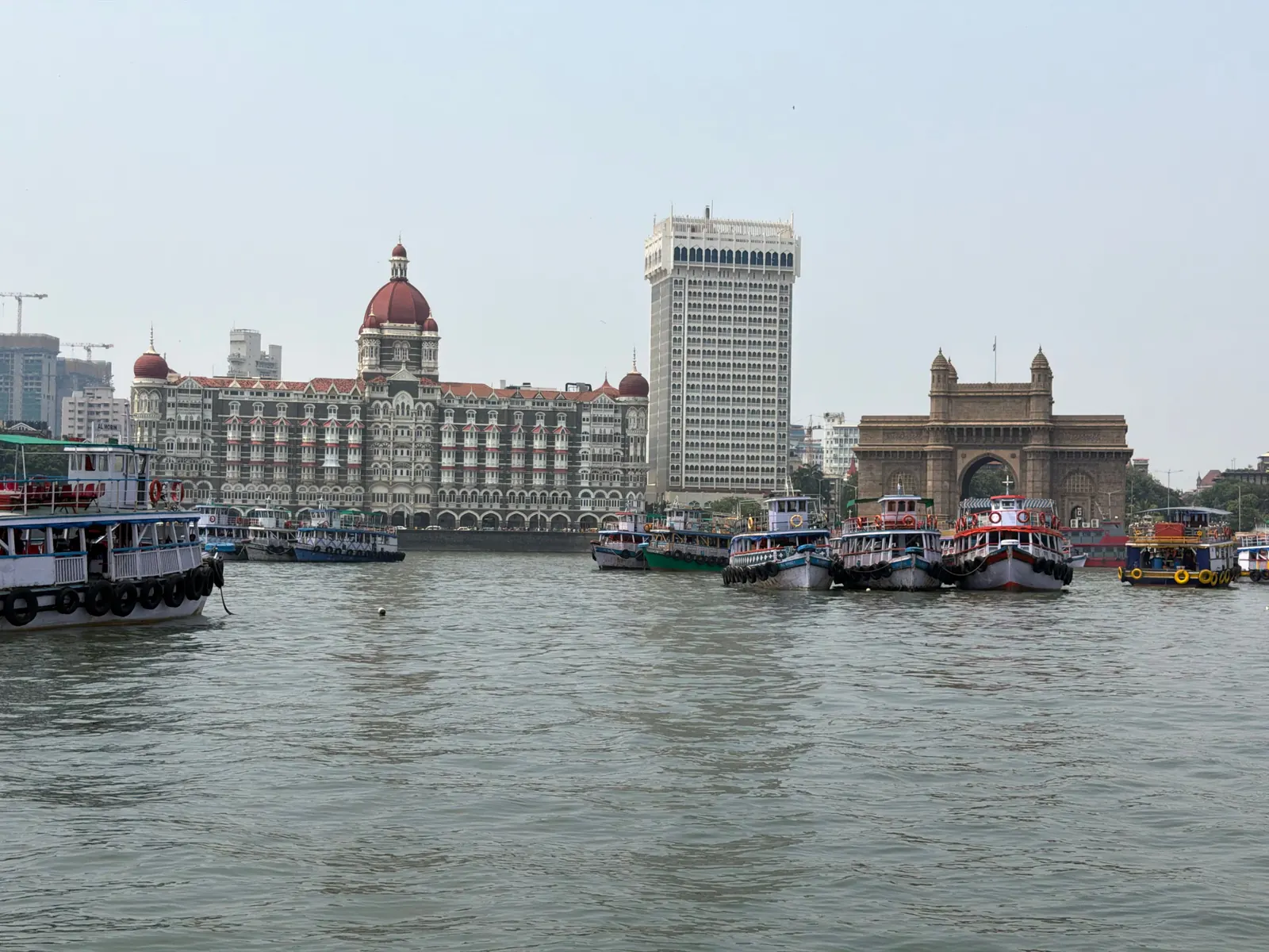 Gateway of India and the red-domed Taj Mahal Palace seen across Mumbai Harbour