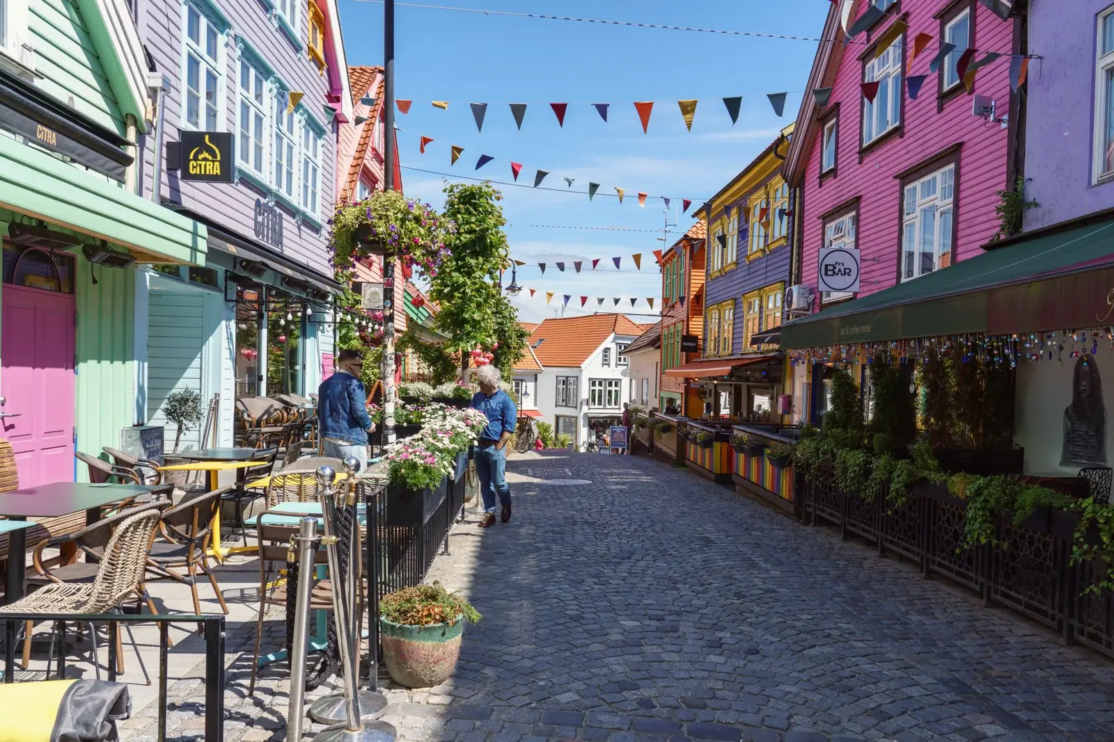 Painted wooden buildings and café terraces on Fargegata in Stavanger
