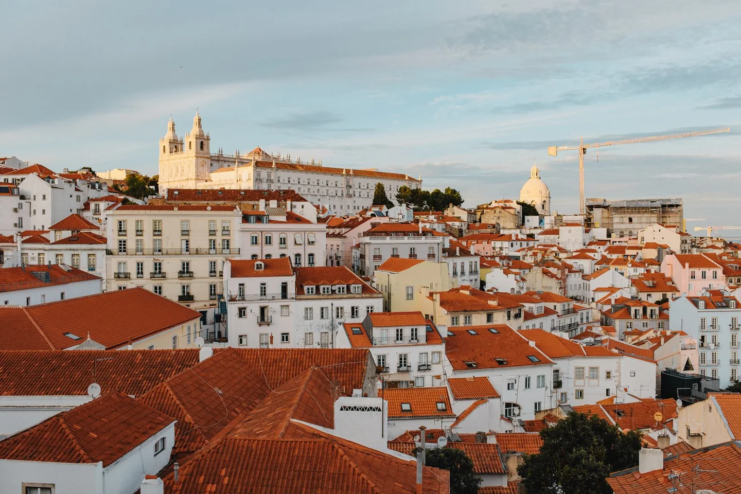 Lisbon's historic rooftops in warm evening light
